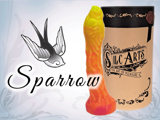The image features the "Sparrow Dildo" from Silc Arts, showcasing the product's vibrant orange color and unique textured design. The dildo has a slender, elongated shape with a flared base, emphasizing its narrow shaft with a sparrow at the tip. 